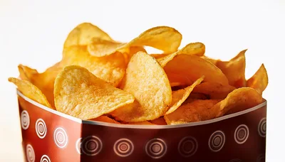 Crispy Potato Chips In A Patterned Red Bowl