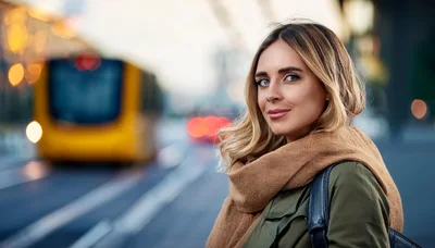 Young Woman Waiting For A Tram In The City