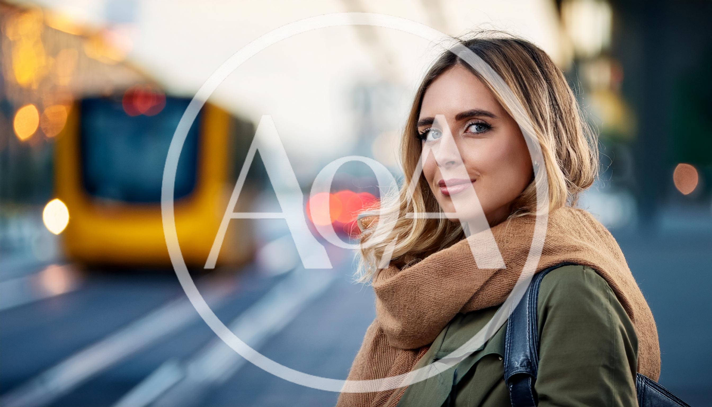 Young Woman Waiting For A Tram In The City