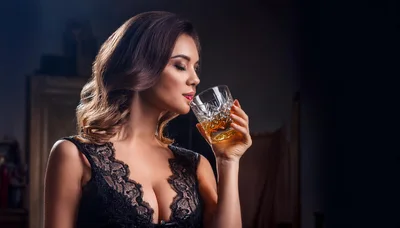 Elegant Woman Drinking Whiskey In A Dimly Lit Room