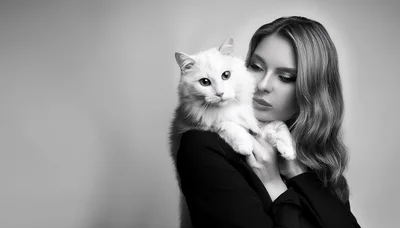 Elegant Woman Holding A Fluffy White Cat