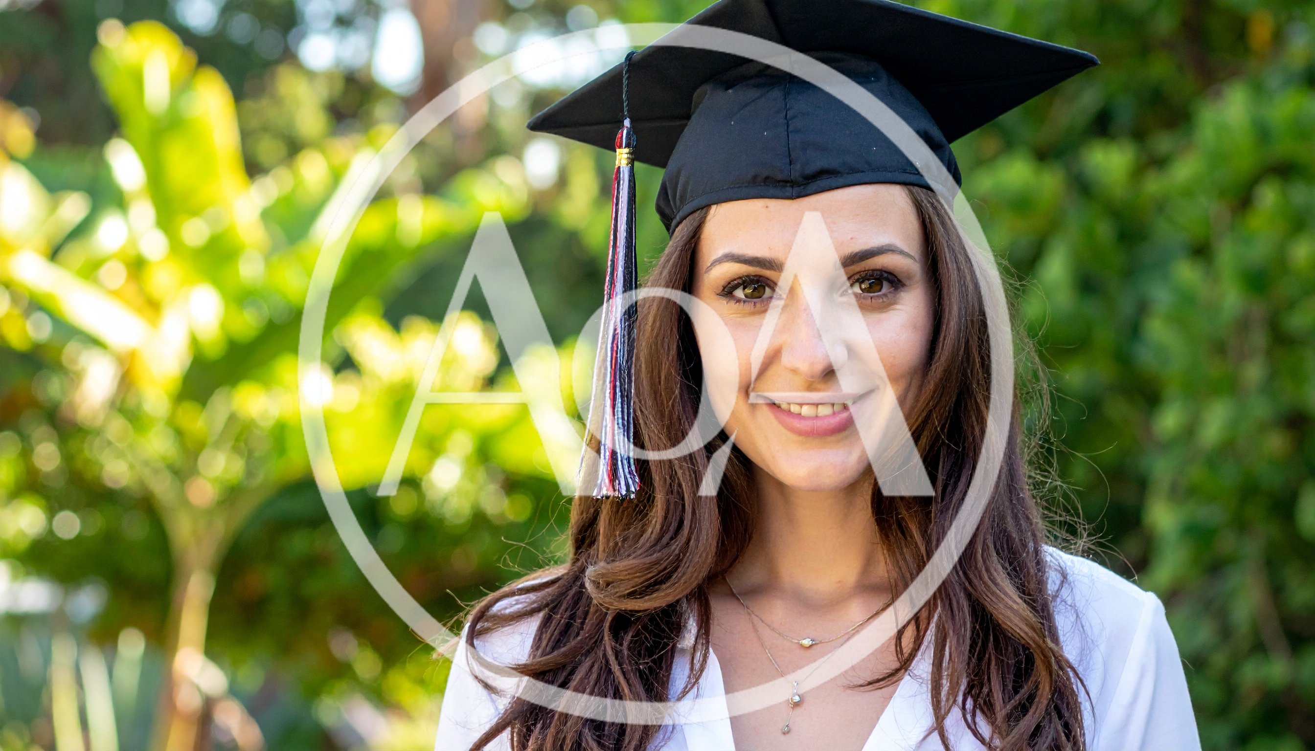 Young Woman Wearing Graduation Cap Outdoors