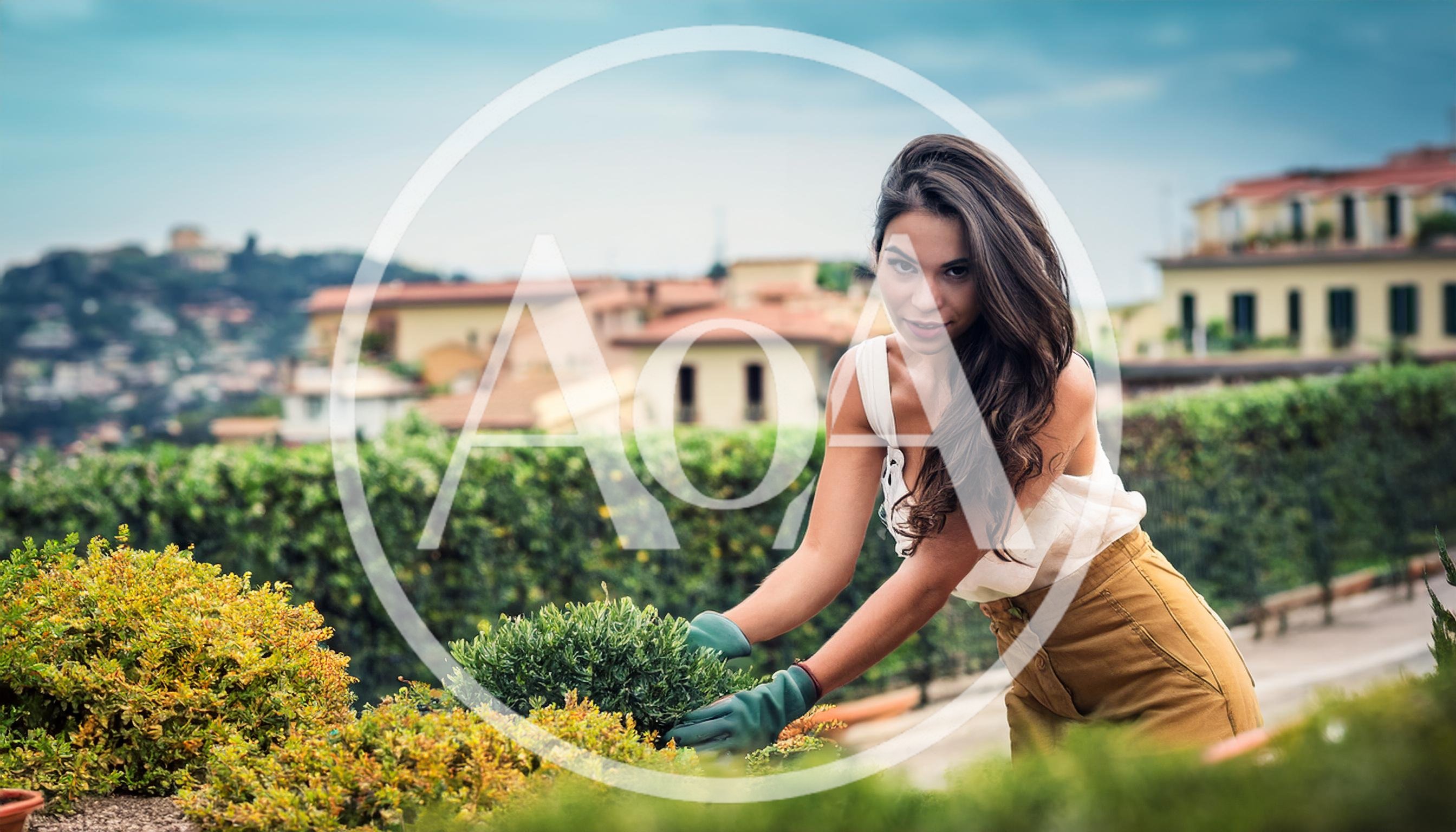Young Woman Gardening In A Sunny Mediterranean Garden