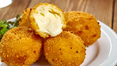 Fried Cheese Croquettes On A White Plate