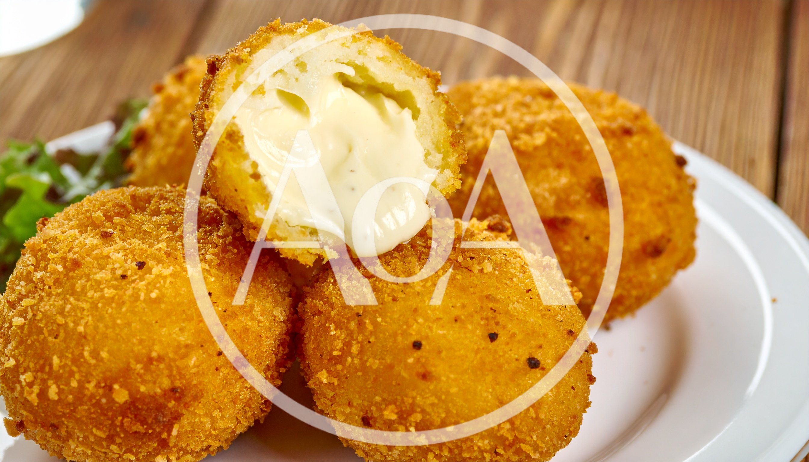 Fried Cheese Croquettes On A White Plate
