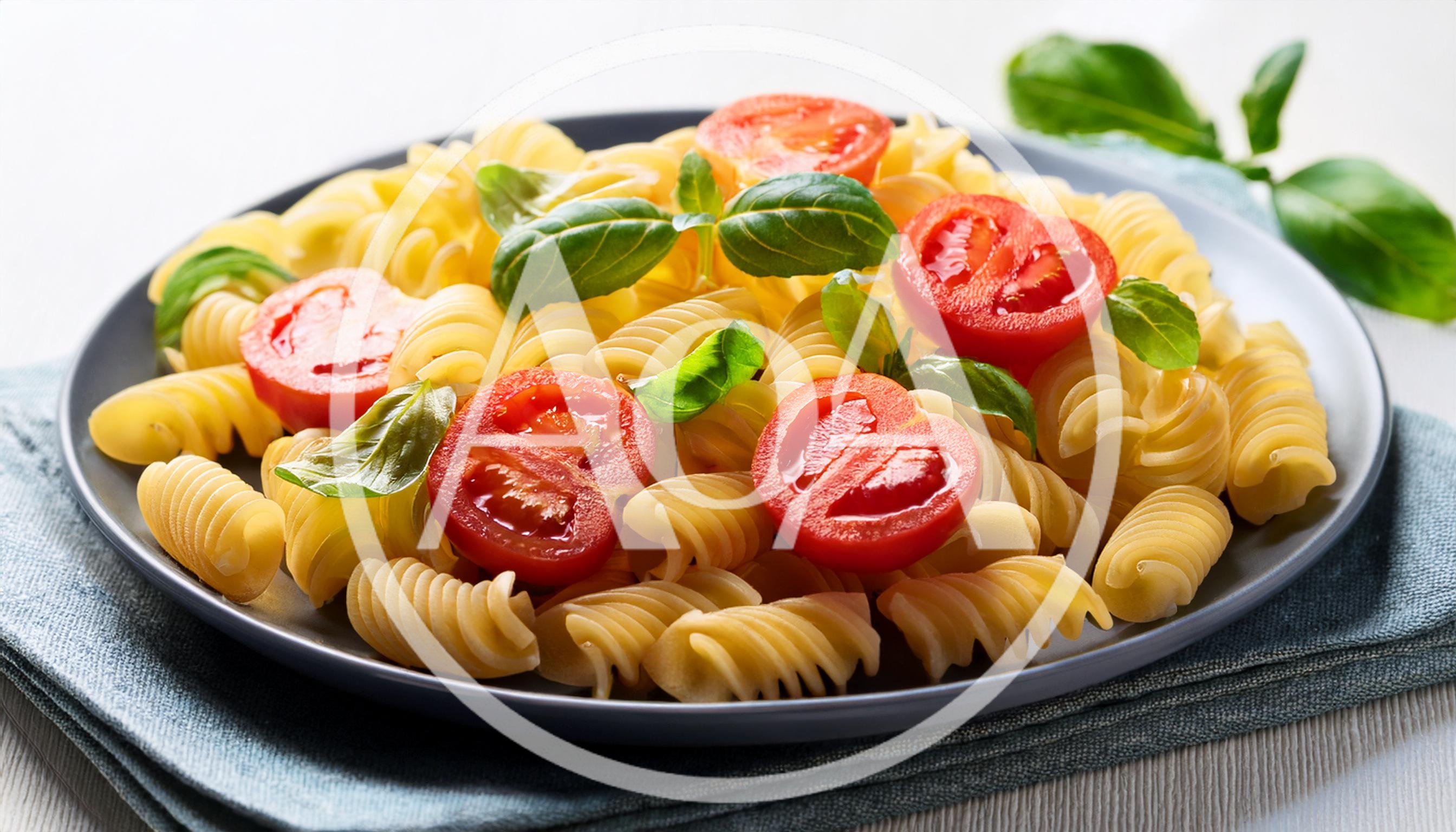 Fusilli Pasta With Fresh Tomatoes And Basil Leaves