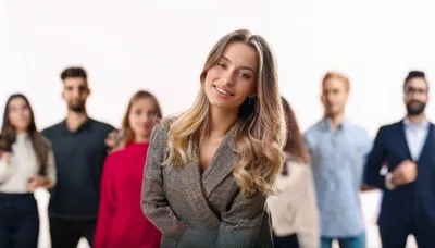 Confident Businesswoman Standing In Front Of Diverse Professional Team