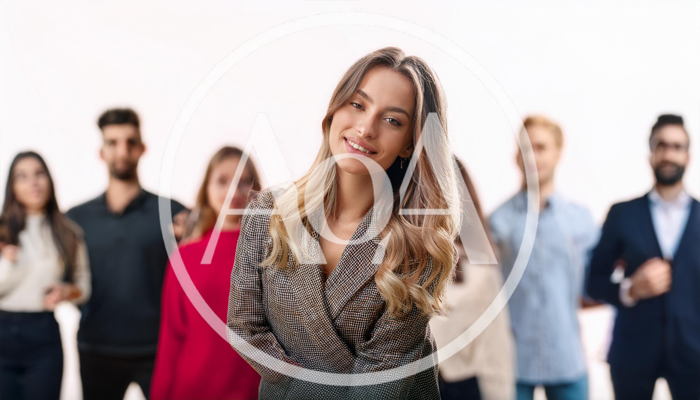 Confident Businesswoman Standing In Front Of Diverse Professional Team