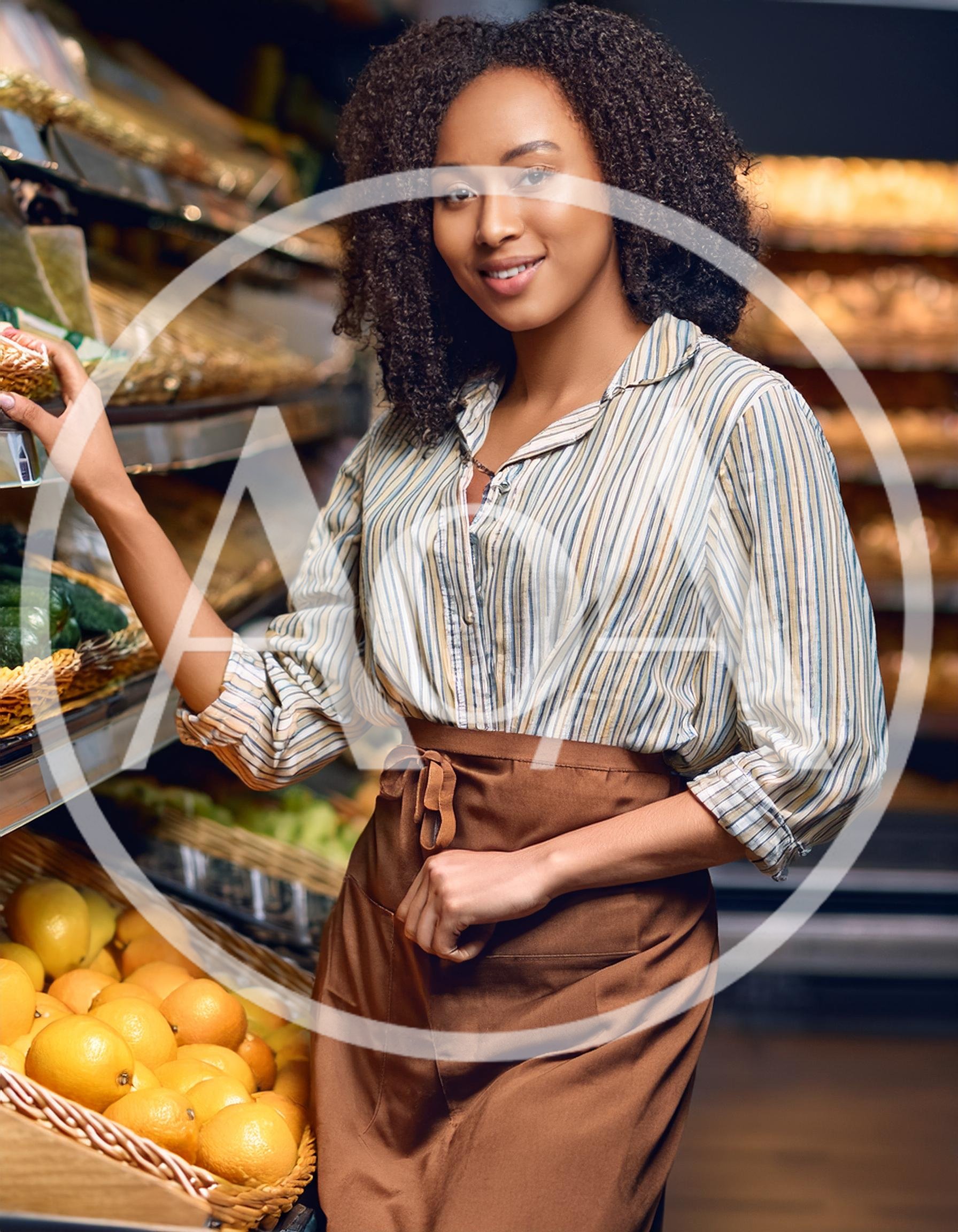 Smiling Female Grocery Store Clerk Arranging Fresh Produce