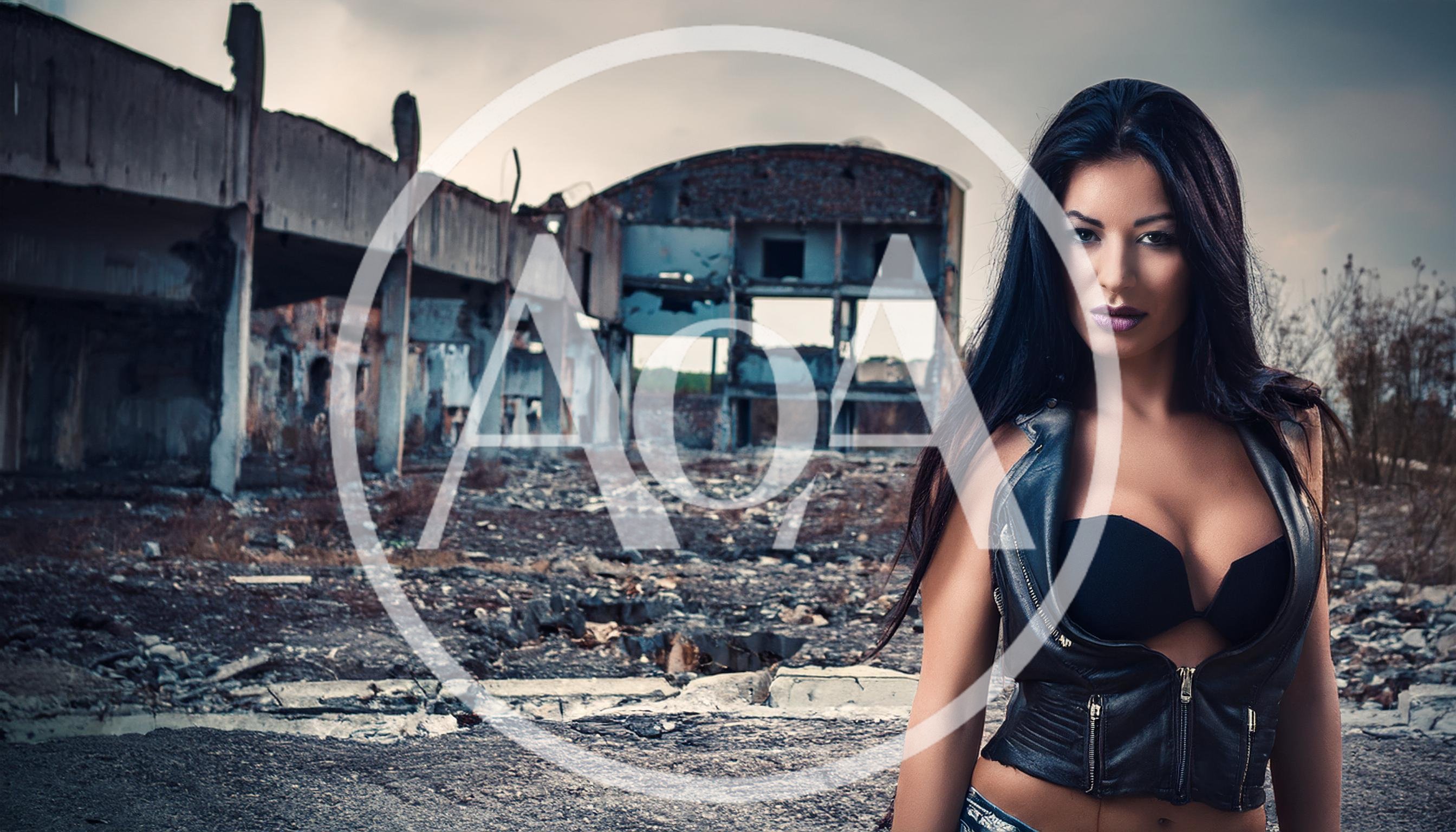 Woman in Leather Vest Standing in Abandoned Industrial Ruins