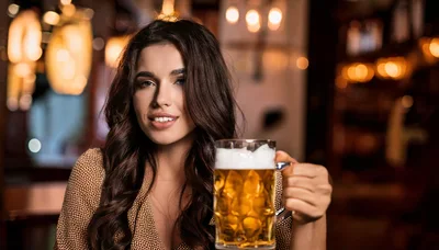Young Woman Holding A Beer Mug In A Pub