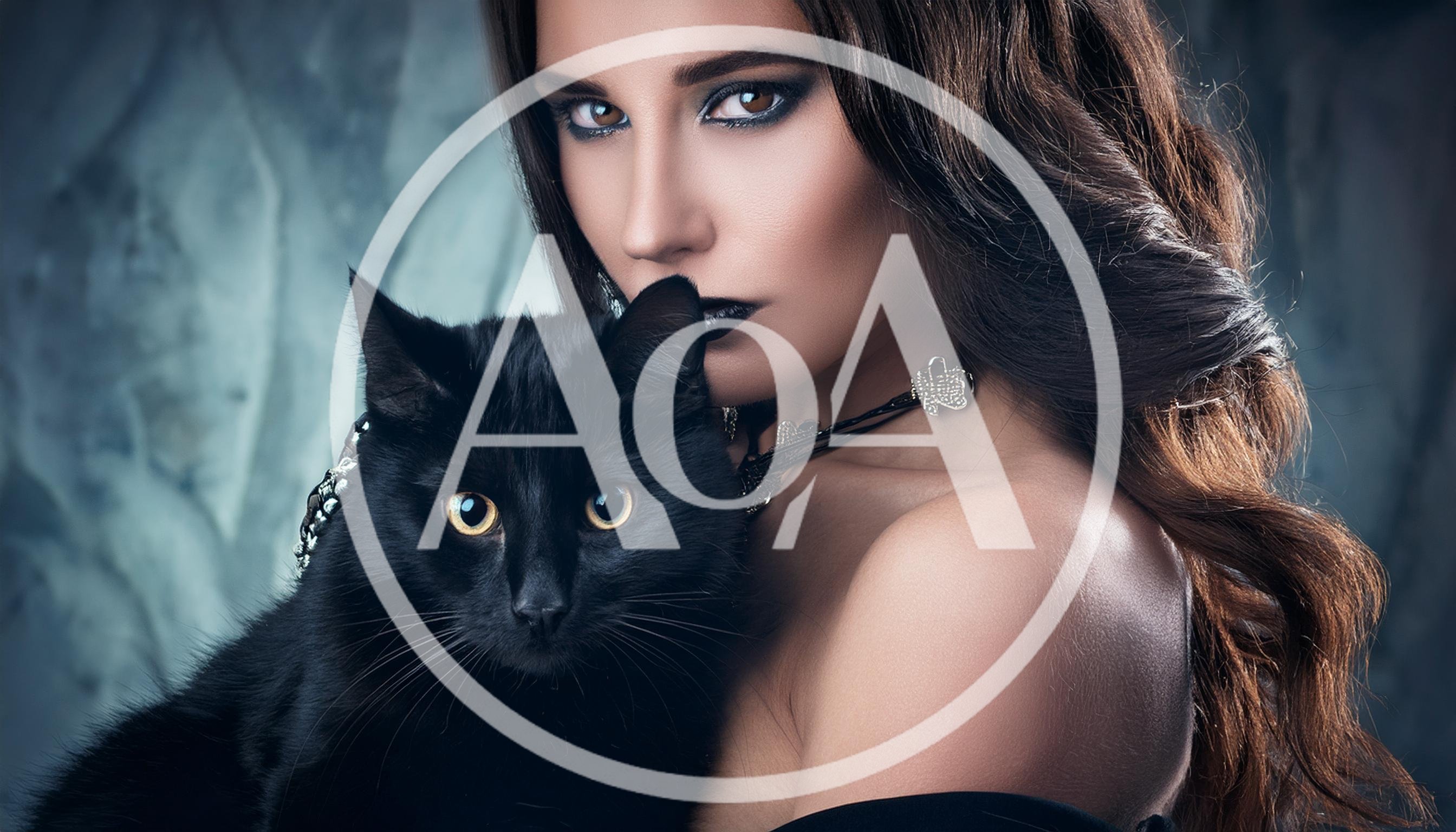 Woman With Dark Makeup Holding A Black Cat
