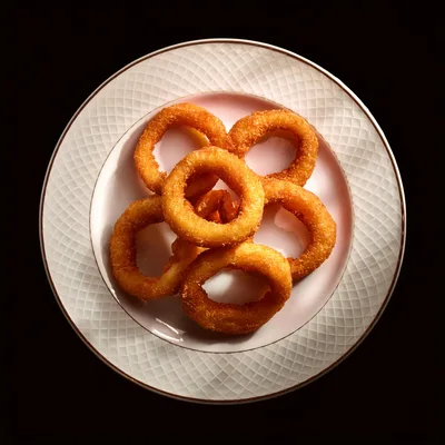 Crispy Golden Fried Onion Rings on a Decorative Plate