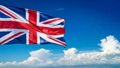 Union Jack Flag Waving Against Blue Sky