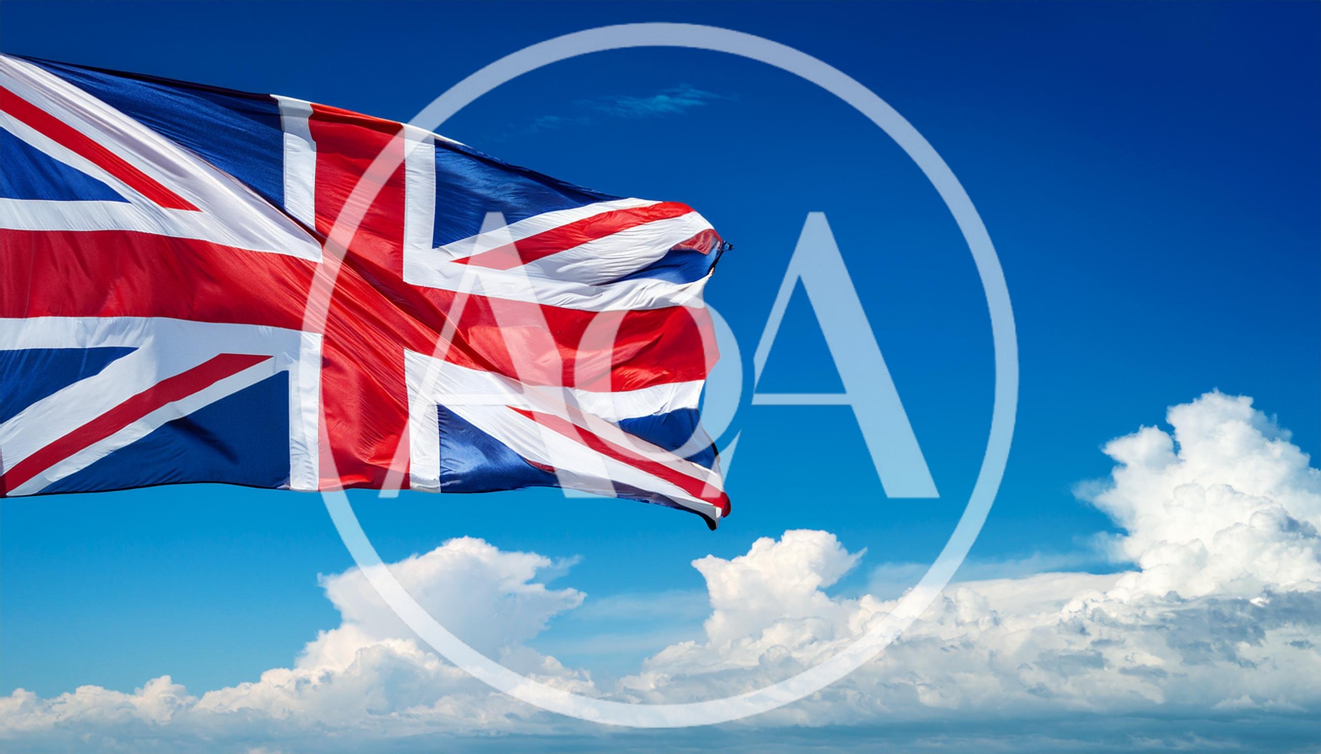 Union Jack Flag Waving Against Blue Sky