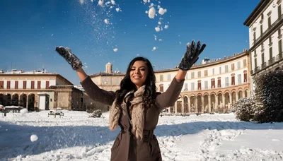 Young Woman Throwing Snow in a Historic Italian Square