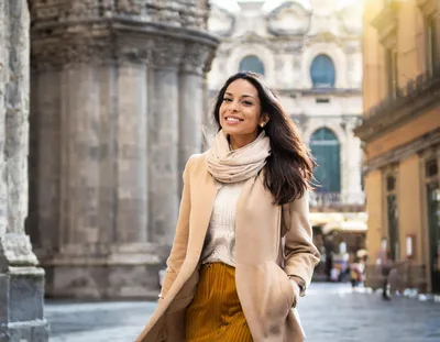 Smiling Woman Walking Through Historic European City Street