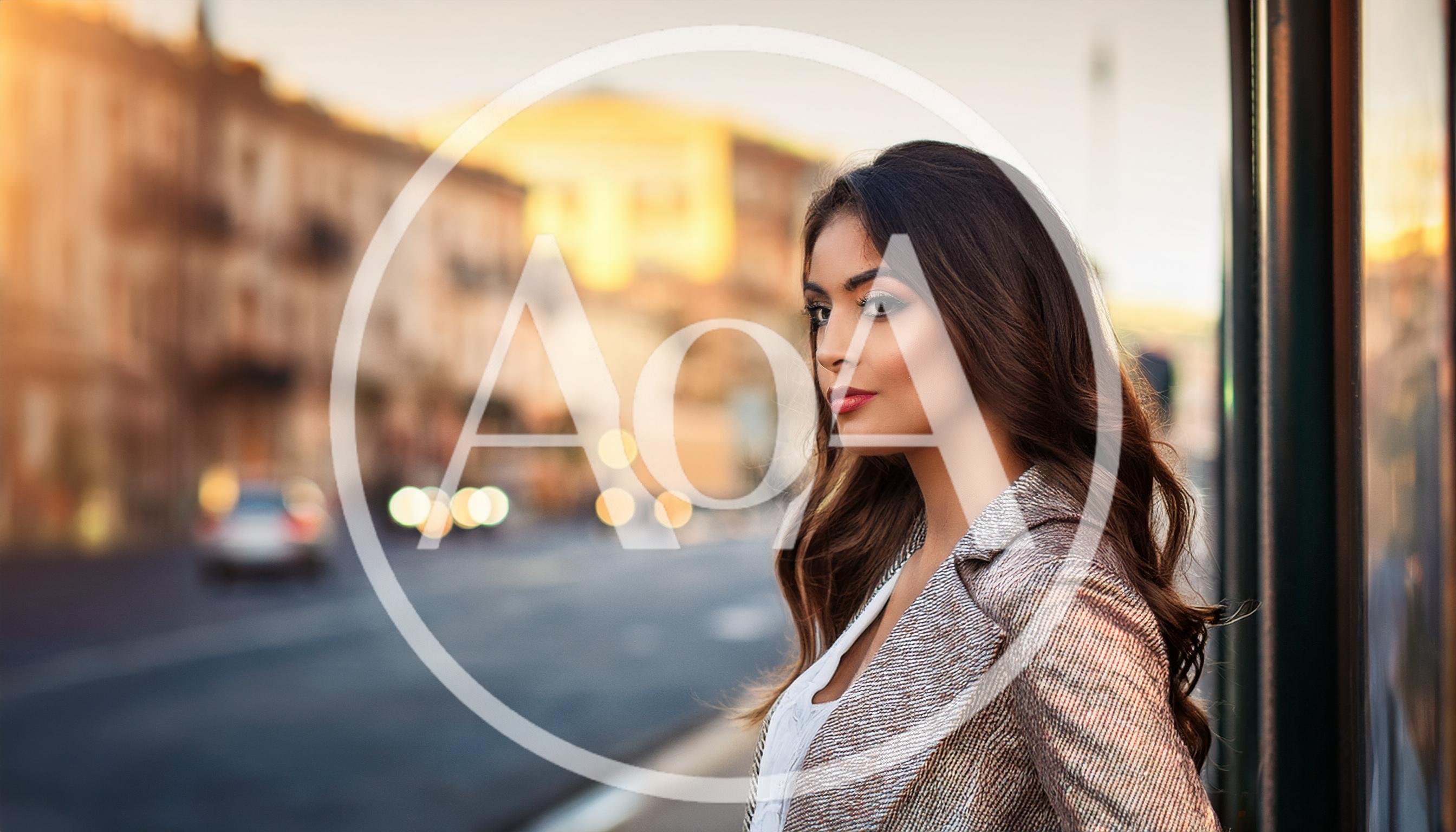 Young Woman Standing Outdoors In City At Sunset
