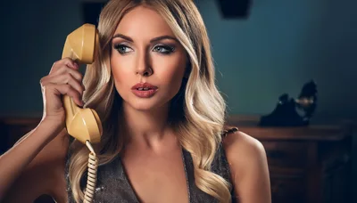 Glamorous Blonde Woman Holding Vintage Telephone Receiver