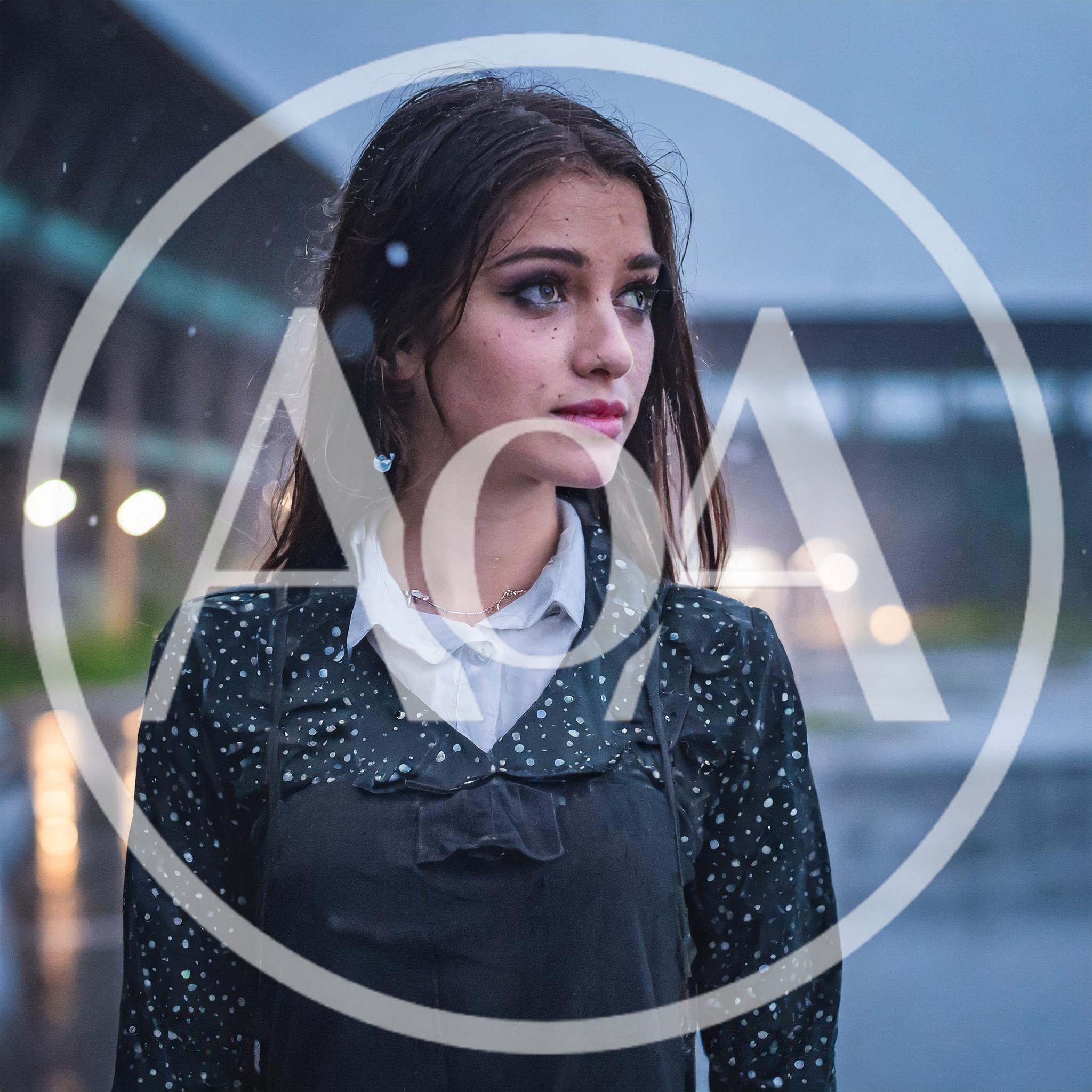 Young Woman Standing Outdoors During A Rainy Evening