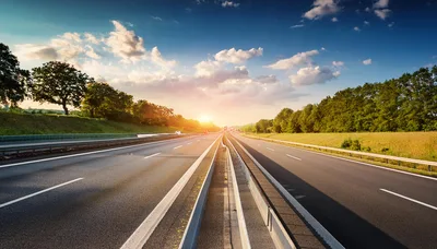 Empty Highway Road Stretching Into Sunset Horizon