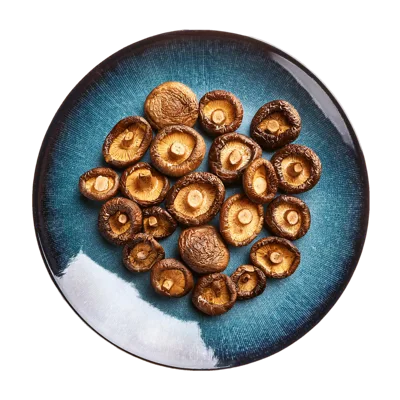 Dried Shiitake Mushrooms On A Blue Ceramic Plate
