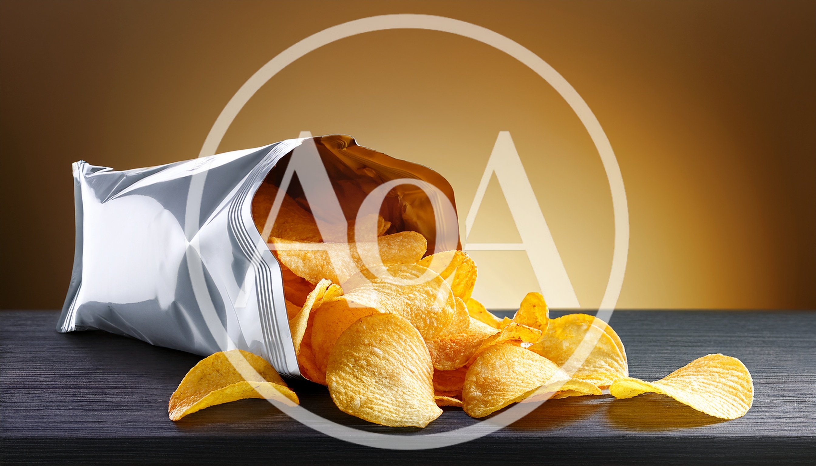 Potato Chips Spilling From A Silver Foil Bag