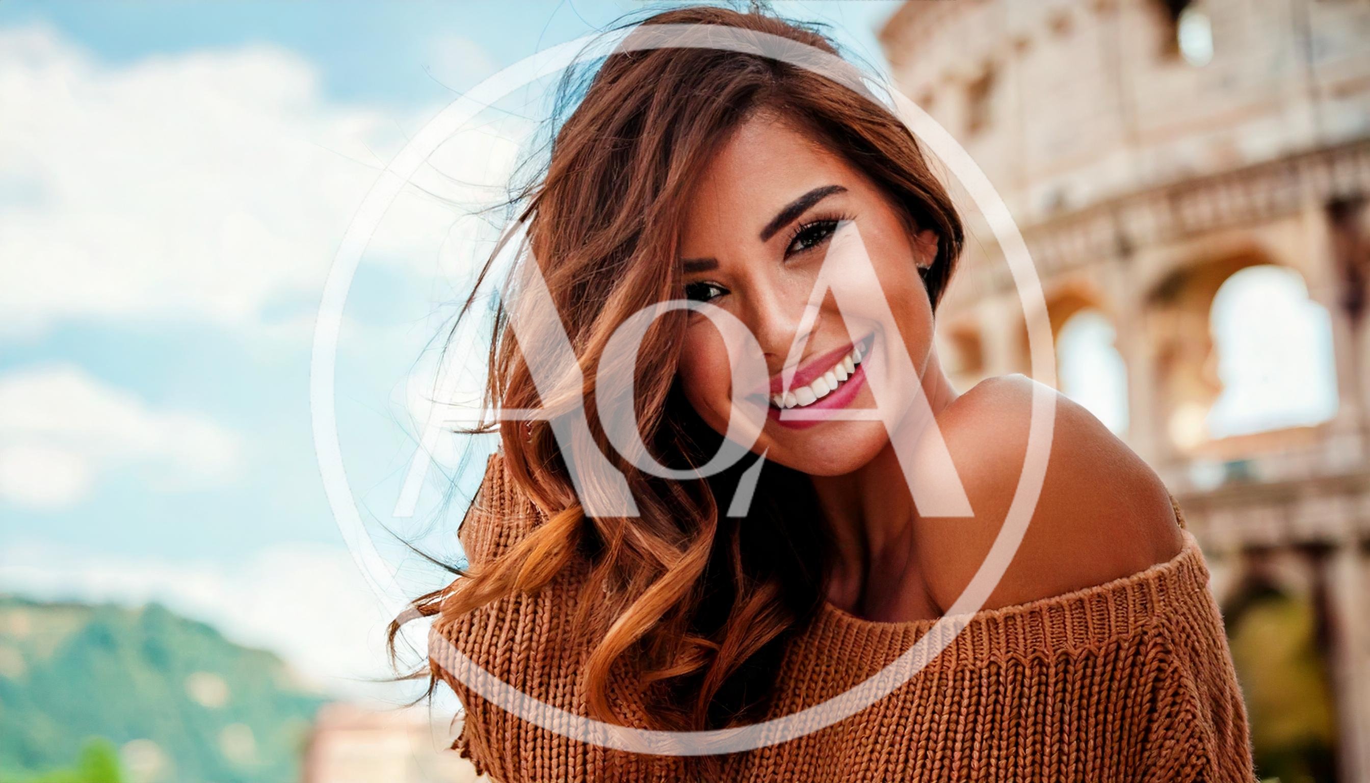 Smiling Woman Posing In Front Of The Roman Colosseum