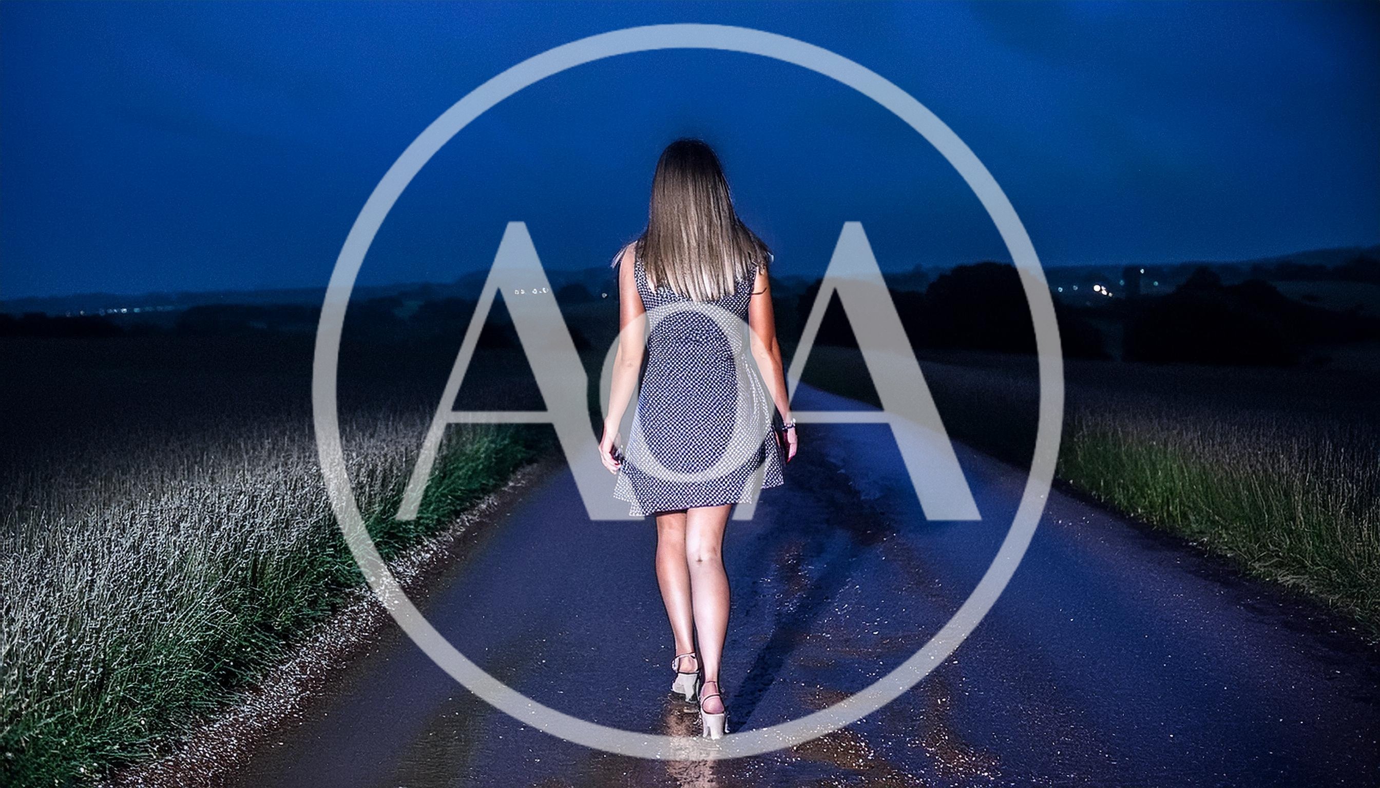 Woman Walking Alone On A Dark Country Road At Night