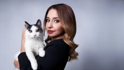Woman Holding A Black And White Cat