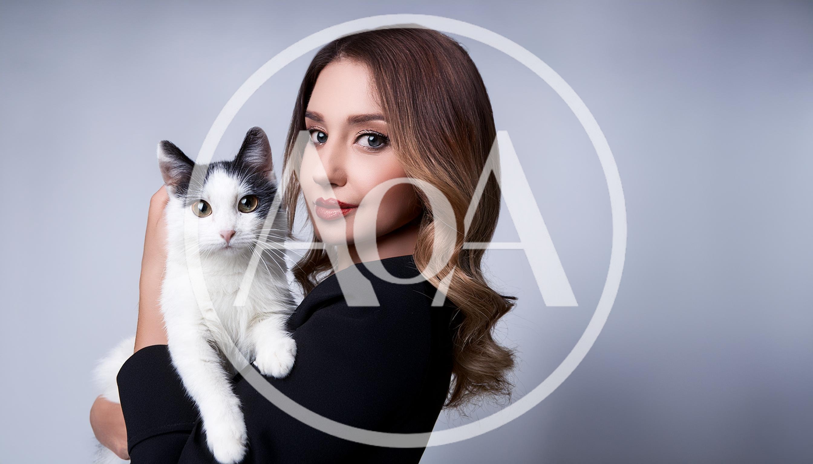 Woman Holding A Black And White Cat
