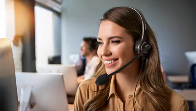 Smiling Customer Service Representative Working In Modern Office