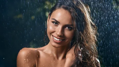 Beautiful Woman Smiling Under Rain Shower