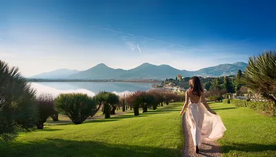 Woman Walking Along A Scenic Lakeside Path