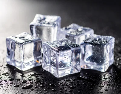 Clear Ice Cubes With Water Droplets On Dark Surface