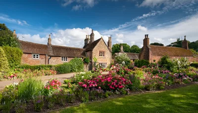 Traditional English Stone Cottage With Vibrant Flower Garden