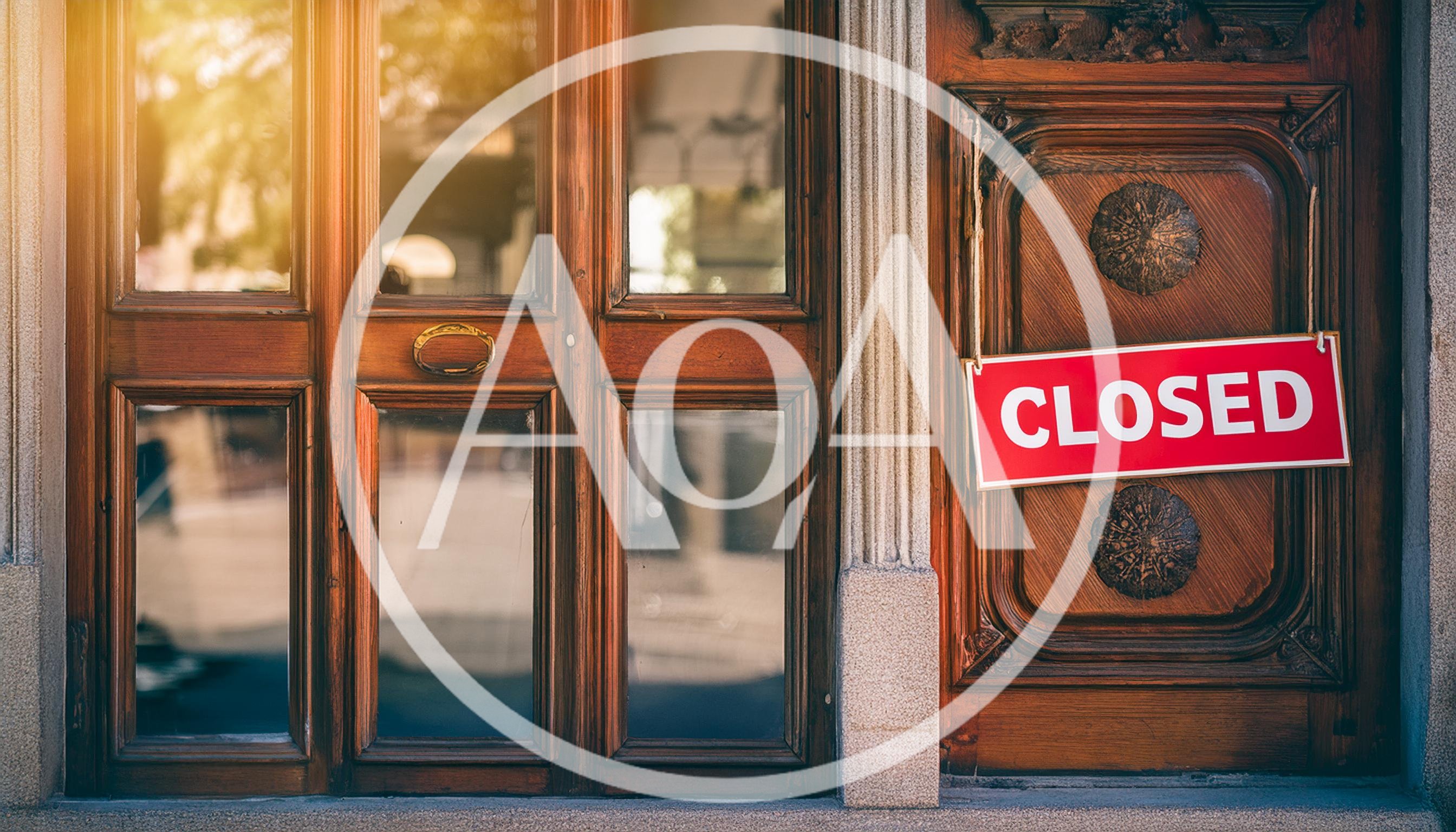 Closed Sign Hanging On A Wooden Storefront Door