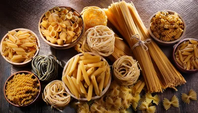Assorted Varieties Of Raw Dry Pasta In Wooden Bowls