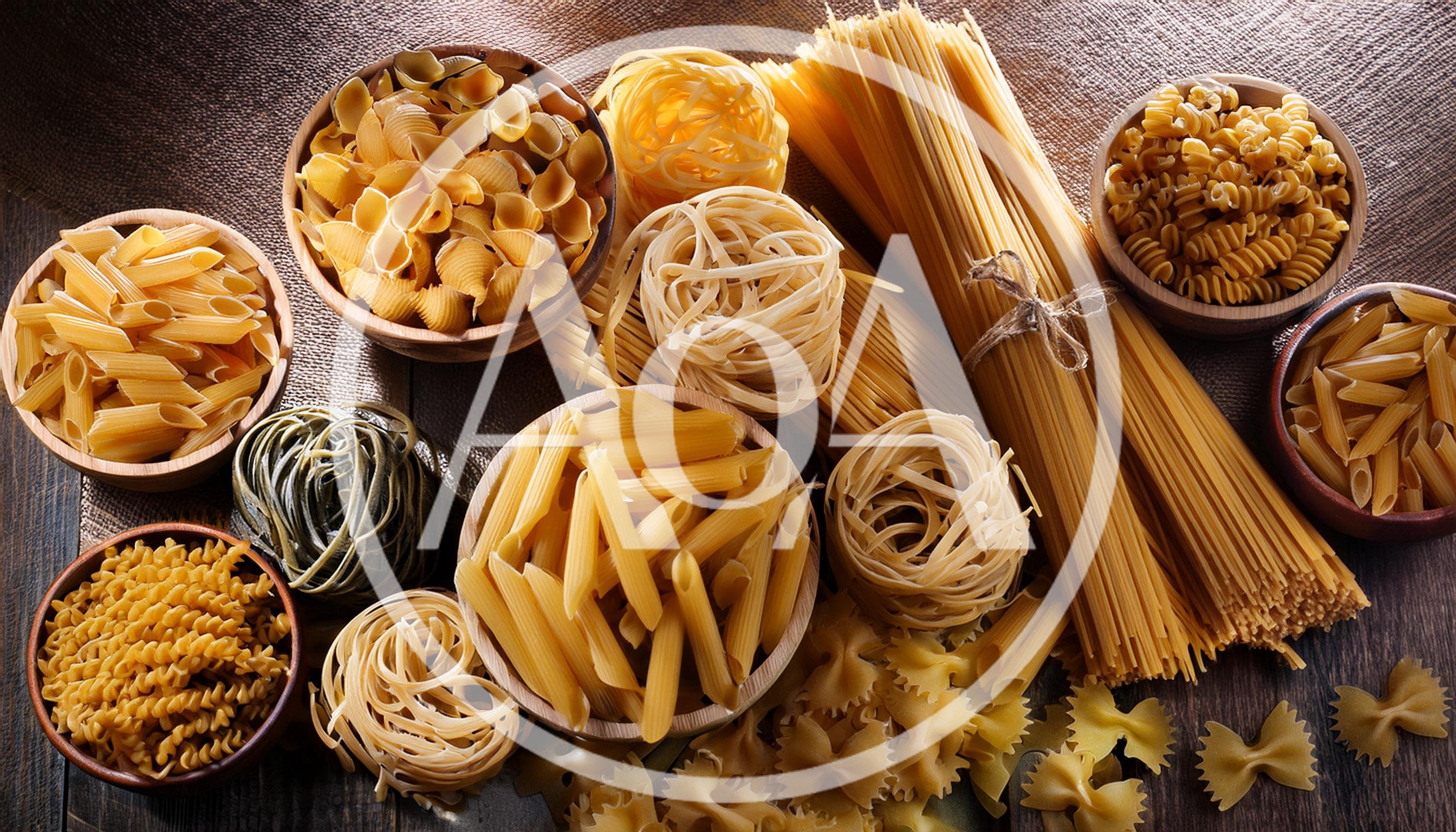 Assorted Varieties Of Raw Dry Pasta In Wooden Bowls