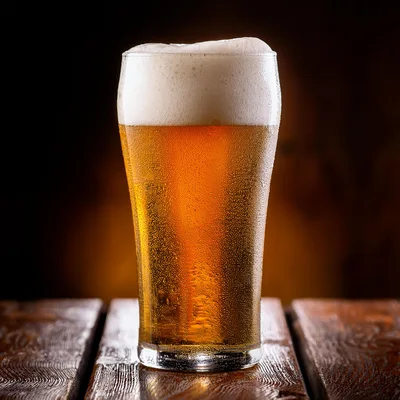 Cold Glass Of Refreshing Golden Beer On Wooden Table