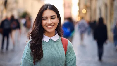Young Woman Smiling In A Busy City Street