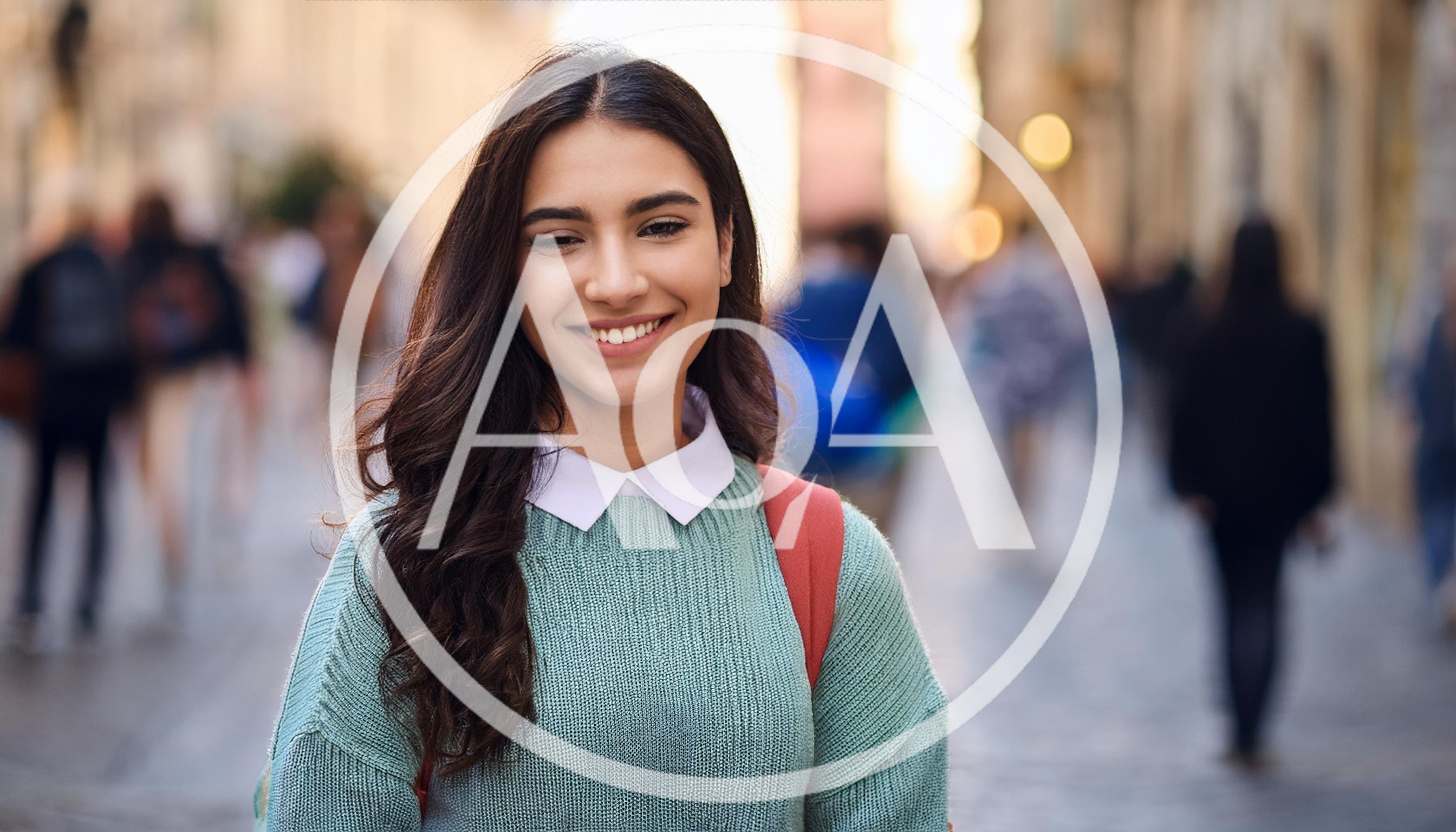 Young Woman Smiling In A Busy City Street