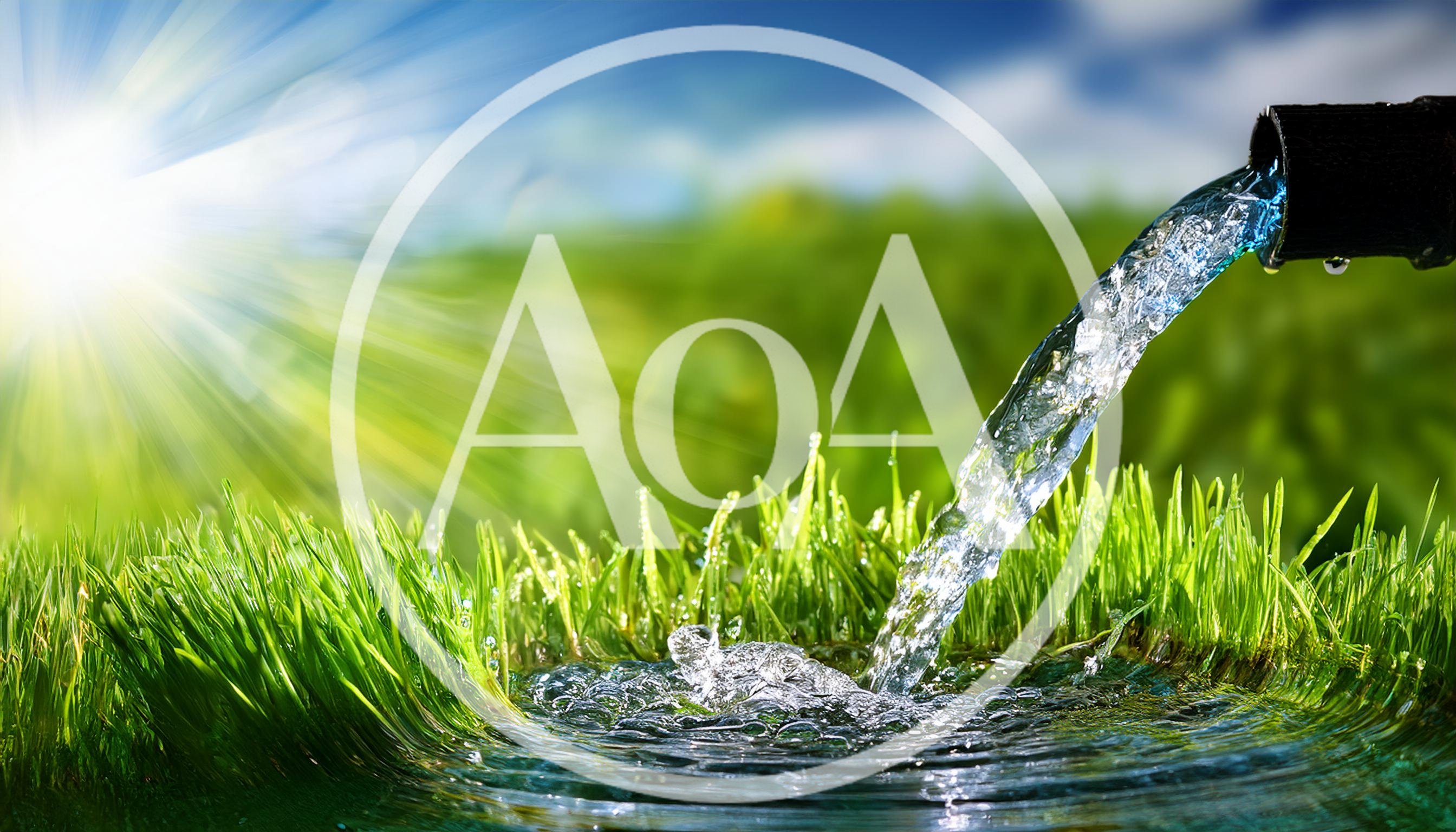 Fresh Water Pouring From Pipe Onto Green Grass