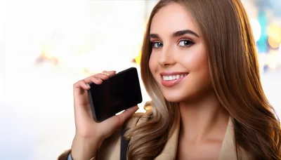Young Woman Holding A Blank Smartphone
