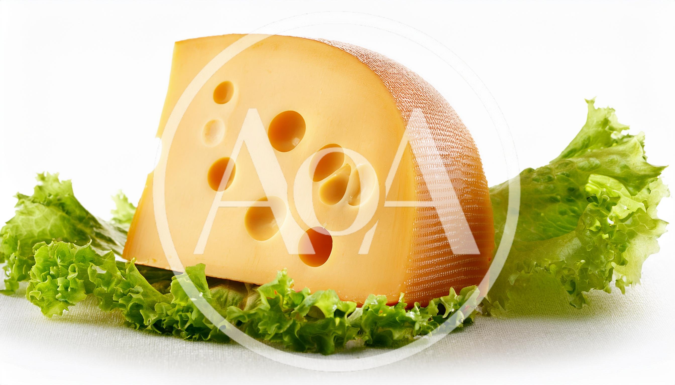 Wedge Of Swiss Cheese On Fresh Green Lettuce