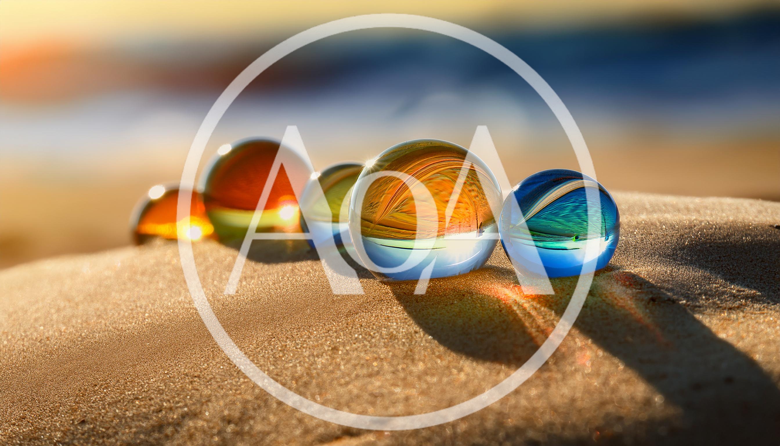 Colorful Glass Marbles Resting On Sandy Beach