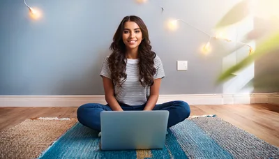 Young Woman Sitting On Rug Using Laptop