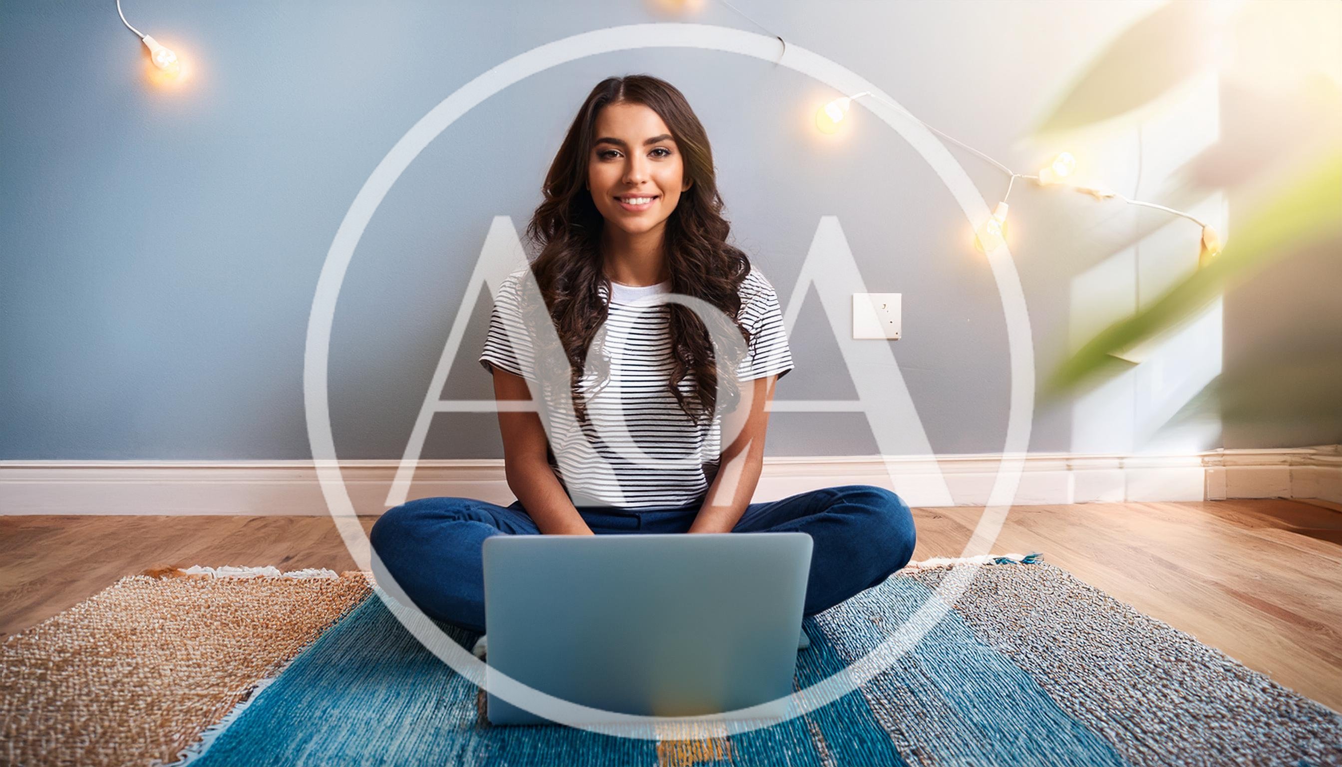 Young Woman Sitting On Rug Using Laptop