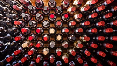 Wine Bottles Stacked In A Dark Cellar