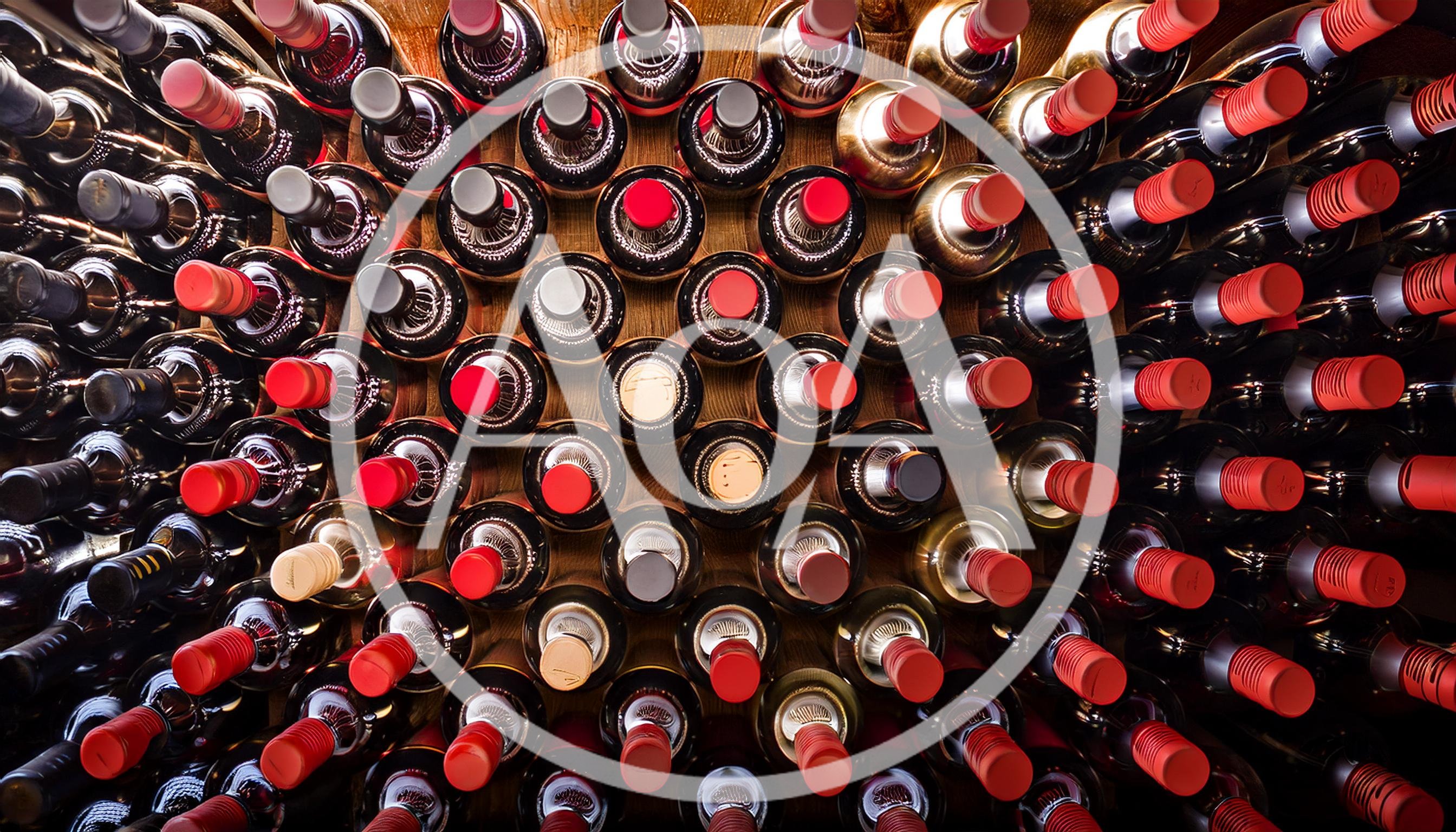 Wine Bottles Stacked In A Dark Cellar
